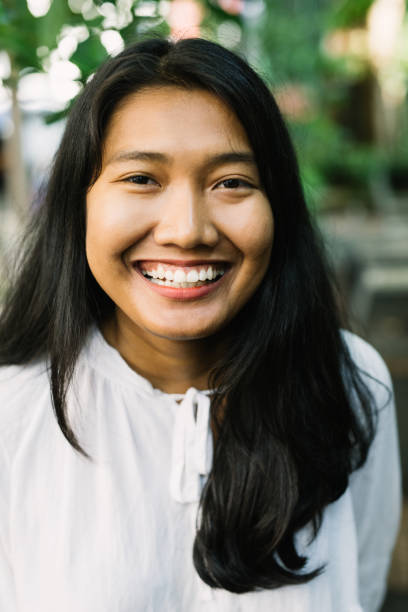 Young beautiful Asian woman with a toothy smile