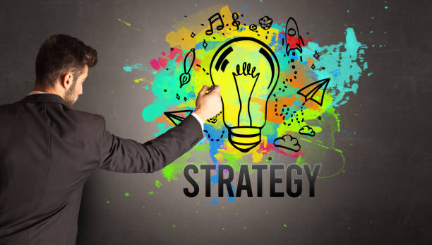 istock businessman drawing colorful light bulb 1220121415