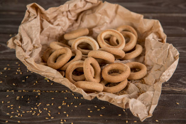 istock Small golden bagels in craft paper 1220121924