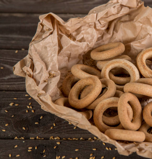istock Small golden bagels in craft paper 1220121956