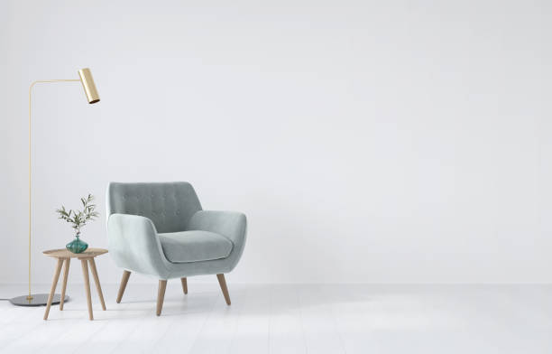 composición interior con un sillón suave, una mesa y una lámpara dorada - contemporary sparse design lamp fotografías e imágenes de stock