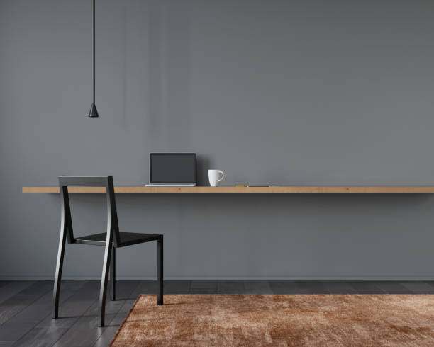 istock Workplace interior with black chair  and a wooden table 1220122061