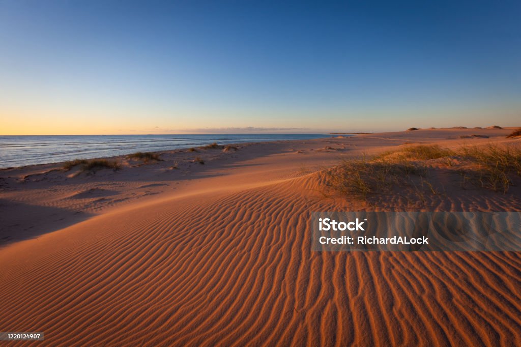 Ningaloo Reef, Western Australia The setting sun emphasises the patterns on the magnificent sand dunes along the coastline of Ningaloo Reef, Western Australia Western Australia Stock Photo
