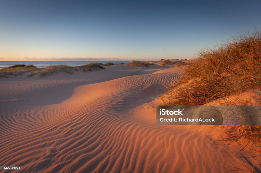 Ningaloo Reef, Western Australia The setting sun emphasises the patterns on the magnificent sand dunes along the coastline of Ningaloo Reef, Western Australia Australia Stock Photo