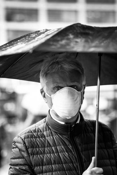 istock Senior man wearing protective face mask outdoors in the city 1220125438