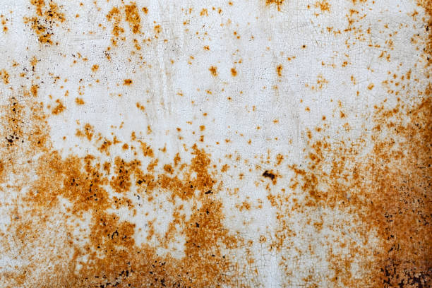 istock Metal surface with white paint that has passed temporary damage, a lot of formed, red rust. 1220125614