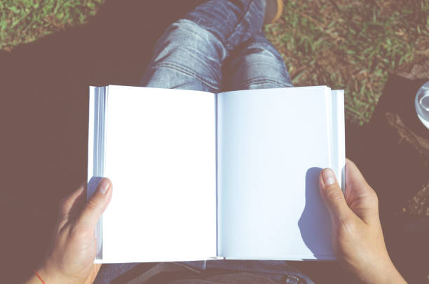 istock A man in jeans with a white notebook in his hands sits in an open-air chair 1220126722