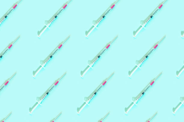 istock Pattern with syringes on blue background. Vaccine cure concept. Coronavirus illness. 1220127356