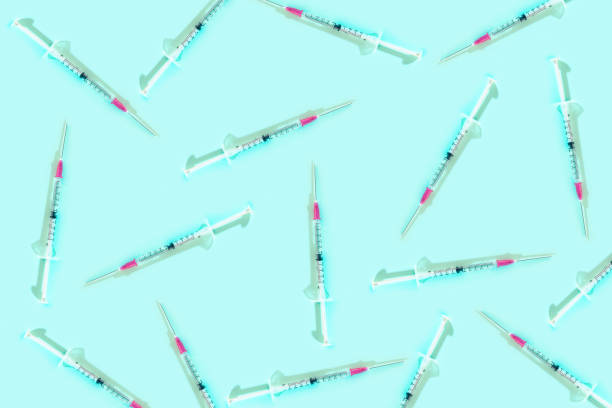 istock Pattern with syringes on blue background. Cure and infection concept. 1220127399
