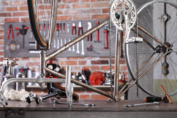 vintage bicycle in garage workshop on the workbench with tools, diy concept