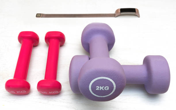 istock Dumbbells and digital watch in a white background 1220131208