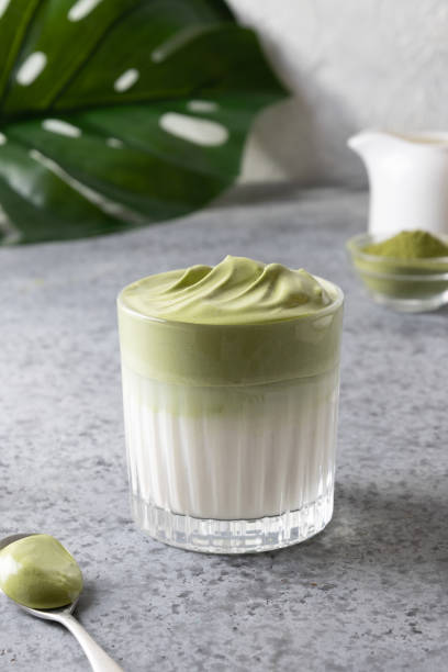 ダルゴナ・アイスティード・抹茶。抹茶入りの白い卵を氷でミルクに加えます。 - green tea ice tea ice cube mint ストックフォトと画像