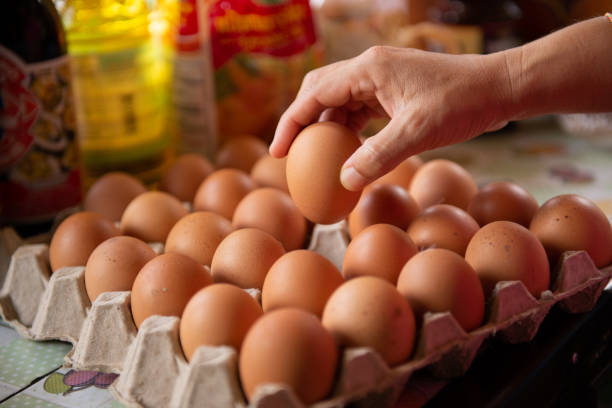 istock The cook takes the eggs from the tray for cooking. 1220132844