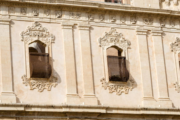 Two ancient windows with baroque decorations in Noto town, Siracusa province, Sicily island, Italy, Europe