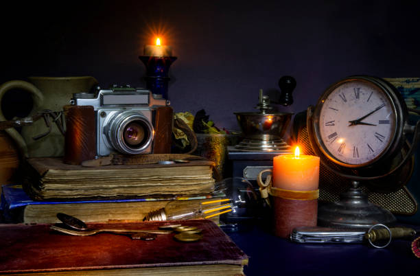 istock Vintage Camera and books collection with clock candles 1220136834