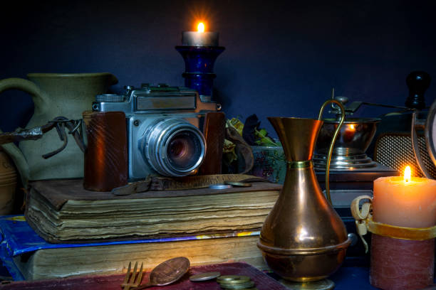 istock Vintage Camera and books arrangement with clock candles 1220136835