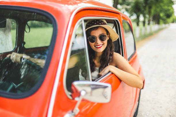 istock Woman driving vintage car 1220137396
