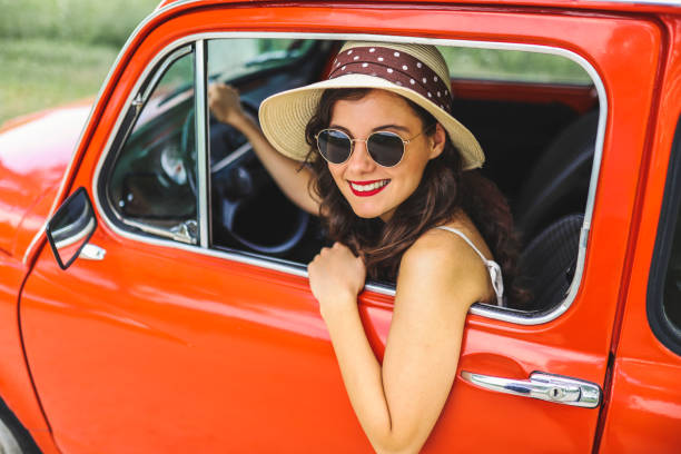 istock Woman driving vintage car 1220137769