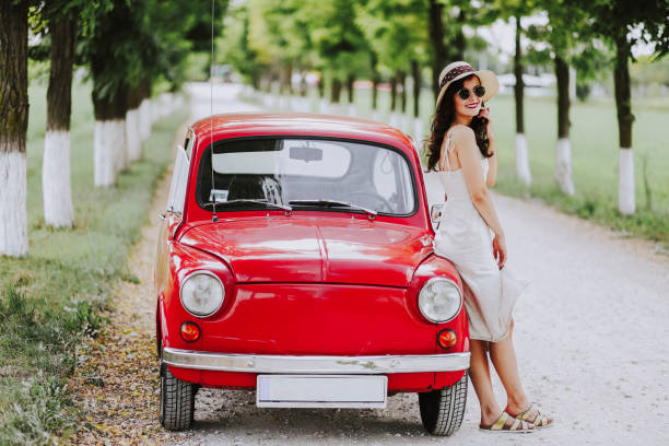 istock Woman and her vintage car 1220138604