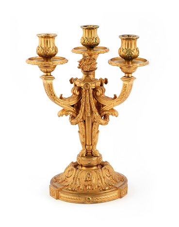 top view of a unique three head antique aarti lamp made of gold brass used for traditional ceremonies and festivals isolated in a white background