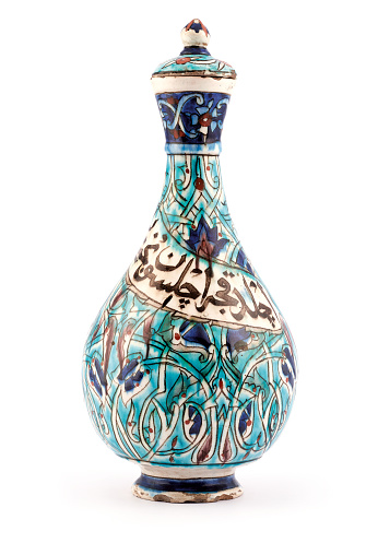 An antique Kutahya ceramic vase on white background.