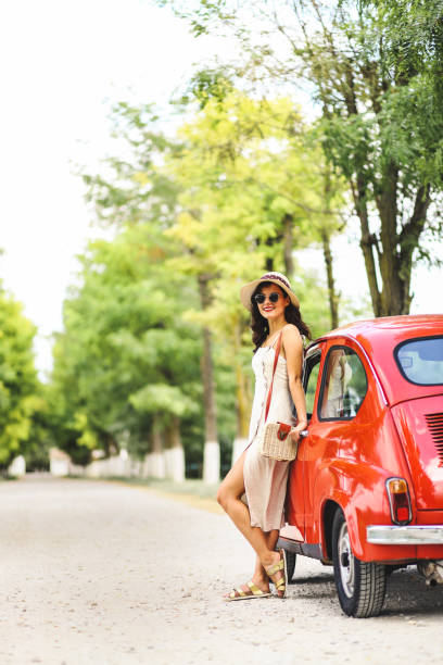 istock Woman and her vintage car 1220139665