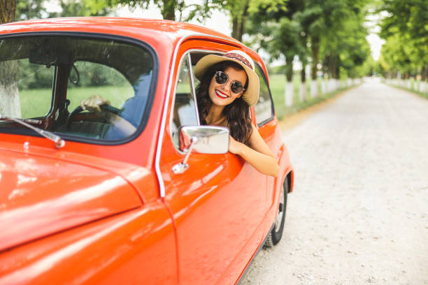 istock Woman driving vintage car 1220139982