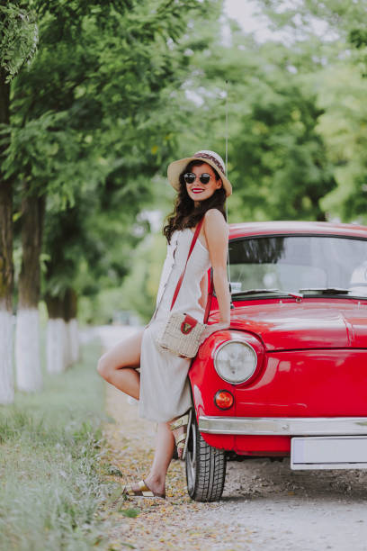 istock Woman and her vintage car 1220140043