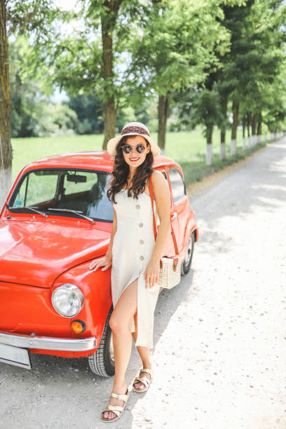 istock Woman and her vintage car 1220140761