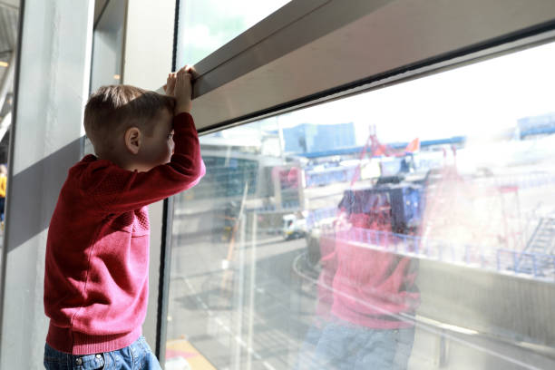 istock Boy waiting for flight at airport 1220142161
