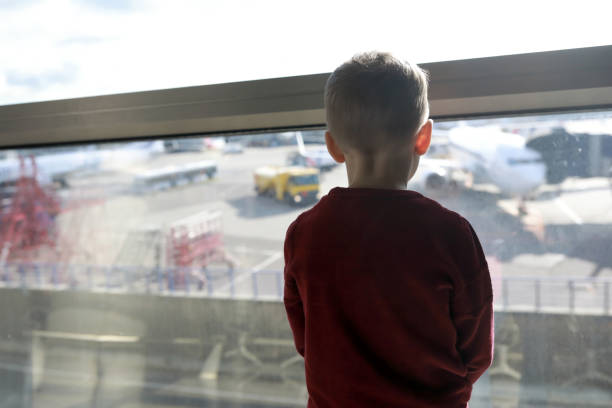 istock Child waiting for flight at airport 1220142175