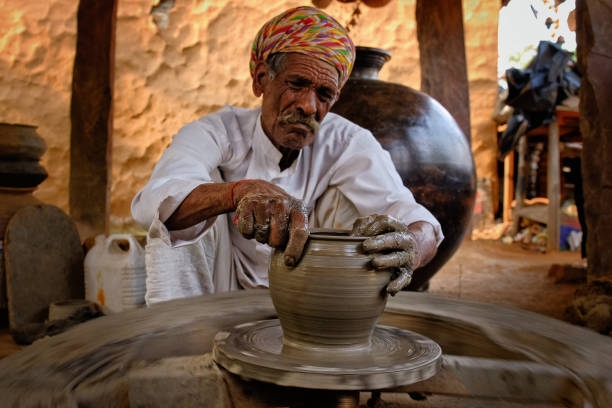 istock Indian potter at work. Handwork craft from Shilpagram, Udaipur, Rajasthan, India 1220143745