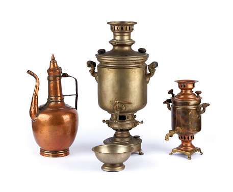 Antique two samovars and an ewer on white background - household equipment