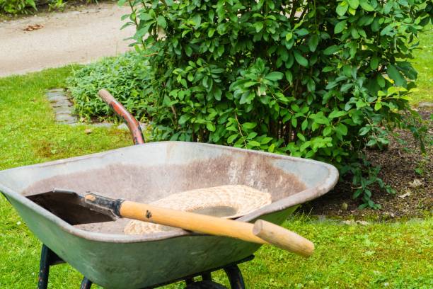 istock Wheelbarrow with Shovel and Straw Hat 1220144107