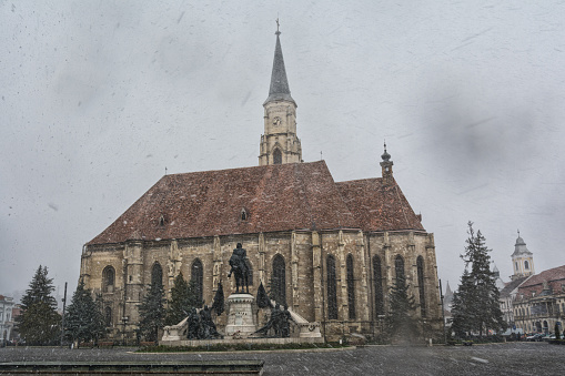 Catholic church in the middle of the city on a snowy day in Cluj, Romania.