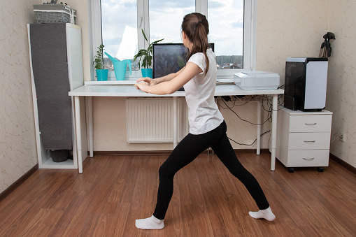 Beauty and health at home during a pandemic quarantine. Young woman dancing online on the internet