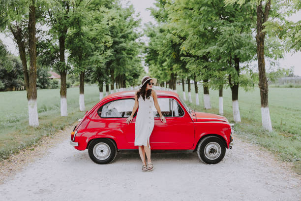 istock Woman and her vintage car 1220145818