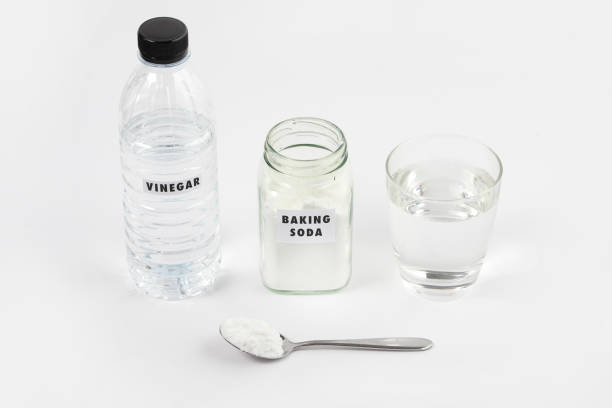 istock Close-Up Of Baking Soda And Vinegar On Table Against White Background 1220145889
