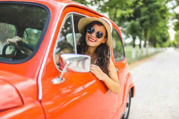 istock Woman driving vintage car 1220146493