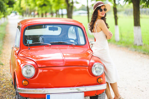 istock Woman and her vintage car 1220147076