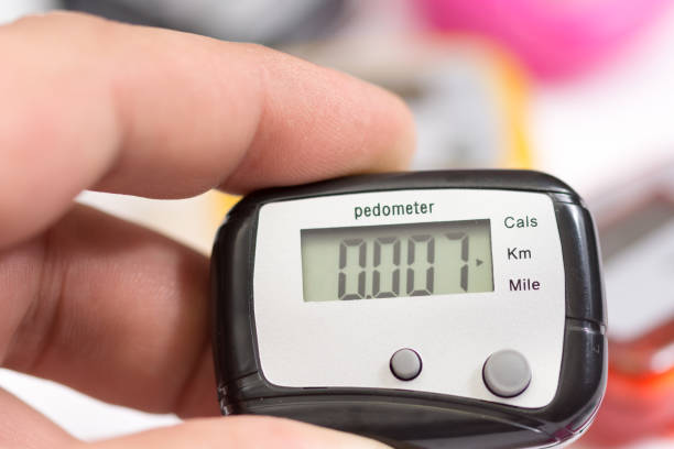 Pedometer in the hand Hand holding black plastic pedometer pedometer stock pictures, royalty-free photos & images