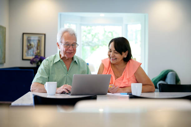 istock Smiling Latin American senior couple working on home finances 1220147355