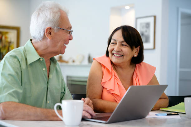 istock Compatible Hispanic senior couple working on retirement plans 1220147360
