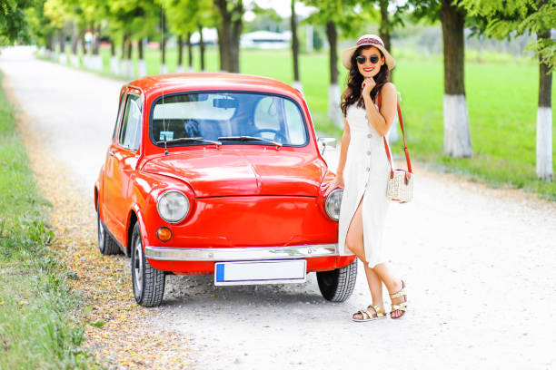 istock Woman and her vintage car 1220147522
