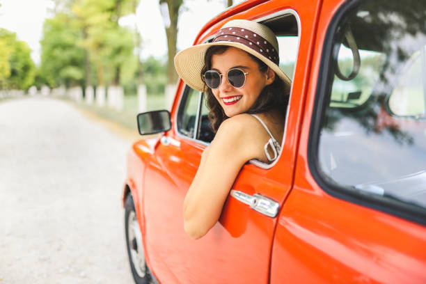 istock Woman driving vintage car 1220147743