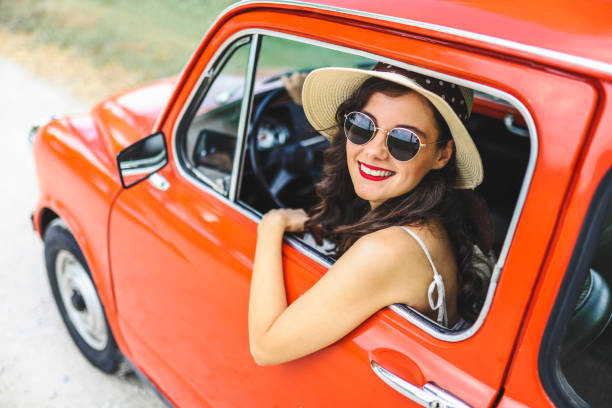 istock Woman driving vintage car 1220147952