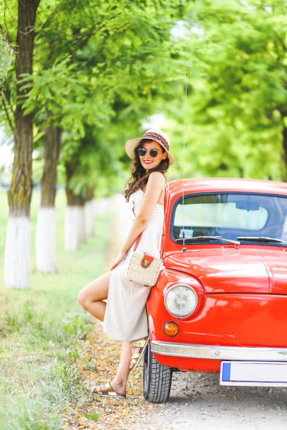 istock Woman and her vintage car 1220148003