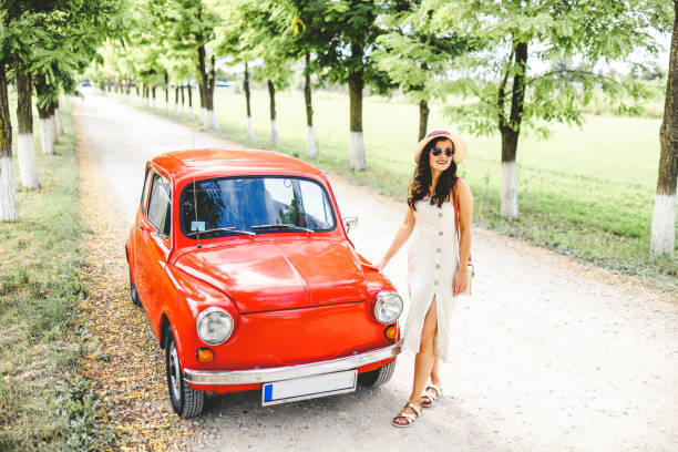 istock Woman and her vintage car 1220148197