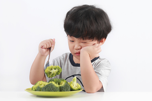Unhappy Little Asian Boy Refuses To Eat Vegetables