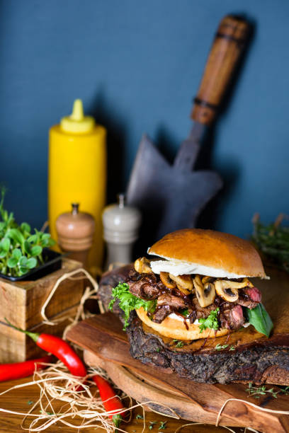 istock Burger with chopped beef steak meat, microgreens and mushrooms. 1220151583